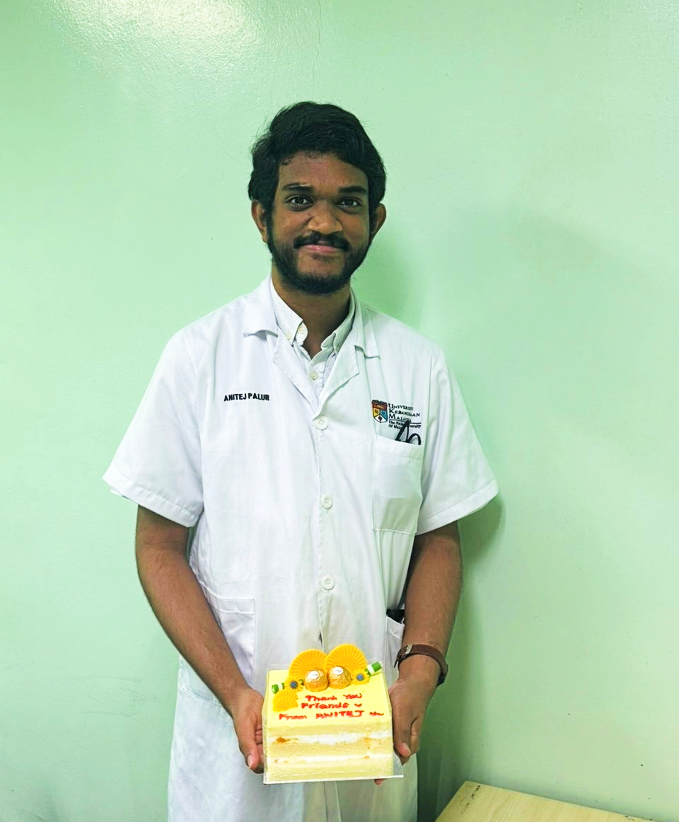 Anitej standing with his cake.